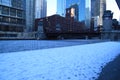 Footprints in snow-covered riverwalk along a frozen Chicago River