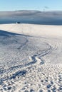 Footprints in snowy landscape at Fimmvoerduhals hiking trail in early morning Royalty Free Stock Photo