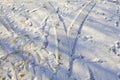 Footprints and tread marks in the snow Royalty Free Stock Photo