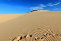 Footprints in the Vietnam sand dune with wind pattern and clear blue sky Royalty Free Stock Photo