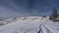 Footprints are visible in the snow-covered valley. Royalty Free Stock Photo