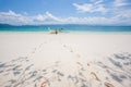Footprints on white sand beach, tourist with boat, and light blu
