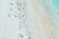 Footprints in the white sand near ocean waves. Indian Ocean coast Zanzibar, Tanzania