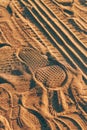 Footstep imprint and tire track tread marks in dust and sand Royalty Free Stock Photo