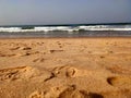 Footstep marks on sand and beach waves Royalty Free Stock Photo