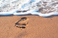 Footstep on the sand and sea spume Royalty Free Stock Photo