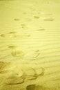 Footsteps in golden sand on the beach Royalty Free Stock Photo