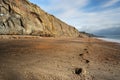 Footsteps lead along the deserted beach at Whale Chine in The Isle of Wight