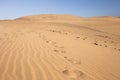 Footsteps on sand dunes against clear blue sky in Maspalomas, Gran Canaria Royalty Free Stock Photo