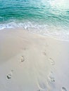 Footsteps on the sand near the water on the beach Royalty Free Stock Photo