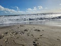 Footsteps in the sand off the Atlantic Ocean shoreline