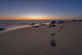 Footsteps in the sand at sunrise