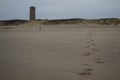 Footsteps in the Sand and Water Tower on a Beach in Domburg, Zeeland, Netherlands Royalty Free Stock Photo