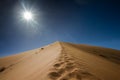 Footsteps on the top of the sand dune