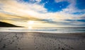 Footsteps tracks in sand on beach with sunrise or sunset. Royalty Free Stock Photo