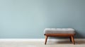 Stylish Footstool By West Elm Against White Wall Photo