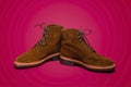 Footwear Concept. Pair of Tan Brown Suede Split Toe High Boots Closeup With Rude Rubber Sole Placed Together On Red Background Royalty Free Stock Photo