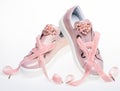 Footwear for girls and women decorated with pearl beads. Femininity concept. Pair of pale pink female sneakers with Royalty Free Stock Photo