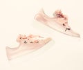 Footwear for girls and women decorated with pearl beads. Trendy sneakers concept. Pair of pale pink female sneakers with Royalty Free Stock Photo