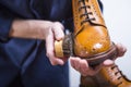 Footwear Ideas. Closeup of Cleaning Male Hands with Cleaning Brush