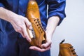 Footwear Ideas. Closeup of Mans Hands with Cleaning Brush