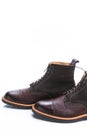 Footwear Ideas. Closeup of Premium Dark Brown Grain Brogue Derby Boots Made of Calf Leather with Rubber Sole Placed in Line Royalty Free Stock Photo