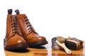 Footwear Ideas and Concepts. Closeup of Tanned Mens Derby Boots With Cleaning Accessories and Wax