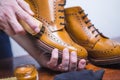 Footwear Ideas. Hands of Professional male Shoes Cleaner