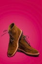 Footwear Ideas. Pair of Tan Brown Suede Split Toe High Boots Closeup With Rubber Sole Placed on One Another Over Pink Red Royalty Free Stock Photo