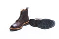Footwear Ideas. Premium Dark Brown Grain Brogue Derby Boots Made of Calf Leather with Rubber Sole Placed With Sole Exposed Over Royalty Free Stock Photo