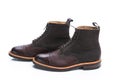 Footwear Ideas. Premium Dark Brown Grain Brogue Derby Boots Made of Calf Leather with Rubber Sole Placed in Line Together Over Royalty Free Stock Photo
