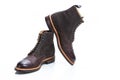 Footwear Ideas. Premium Dark Brown Grain Brogue Derby Boots Made of Calf Leather with Rubber Sole Placed on One Another Over White Royalty Free Stock Photo