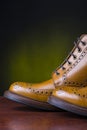 Footwear and shoes concepts. Pair of premium tanned brogue derby boots