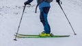 Footwork detail of a person performing a 180 degree turn while ski touring or mountaineering. Person making a turn on skis walking Royalty Free Stock Photo