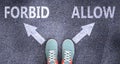 Forbid and allow as different choices in life - pictured as words Forbid, allow on a road to symbolize making decision and picking Royalty Free Stock Photo