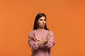 It is forbidden. Portrait of serious woman in pink sweater, makes denial hand gesture, keeps arms crossed over chest, demonstrates Royalty Free Stock Photo