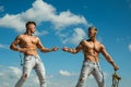 Force and power. Twins competitors with muscular bodies. Strong men pull rope with muscular hand strength. Men shows off Royalty Free Stock Photo