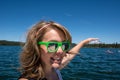 Forced perspective of a female holding her hand appears to be touching Mt. Bachelor