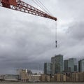 Forced perspective makes a crane appear gigantic over Canary Wharf