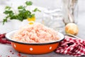 Forcemeat. Raw ground chicken meat in bowl on white kitchen table. Fresh minced chicken breast meat