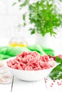 Forcemeat. Raw ground pork meat in bowl on white kitchen table. Fresh minced meat