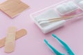 Forceps, plasters, cotton ball, gauze  Sterile dressing set  on pink background. First aid kit at home, healthcare and medical Royalty Free Stock Photo