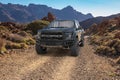 Ford F-150 Raptor on a desert road in the mountains