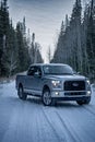 Ford F150 Silver Truck Car 4x4 on a road covered by now Royalty Free Stock Photo