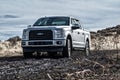 Ford F150 Silver Truck Car 4x4 SUV driving in the mud Royalty Free Stock Photo