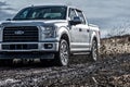 Ford F150 Silver Truck Car 4x4 SUV driving in the mud Royalty Free Stock Photo