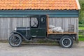 Black Ford Model T pick-up truck in front of an old shed Royalty Free Stock Photo