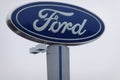 The Ford Motor Company logo as seen isolated on a tall sign at a car dealership. Ford`s headquarters are in Dearborn, Michigan Royalty Free Stock Photo