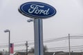 The Ford Motor Company logo as seen on a tall sign at a car dealership. Ford`s headquarters are in Dearborn, Michigan Royalty Free Stock Photo