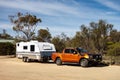 Ford Ranger Wildtrack off road pickup car with air intakes and a white caravan trailer in Western Australia